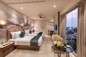 a hotel room with a large bed and a balcony at SkkyLight Lords Inn Nanded in Nānded +36 photos