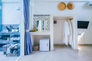 a dressing room with blue curtains and a mirror at Villa on Air in Gili Islands