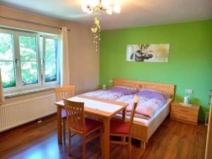 a bedroom with a bed and a table and chairs at Tischnerhof Appartements in Bad Kleinkirchheim