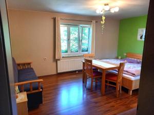 a room with a table and a bed and a bedroom at Tischnerhof Appartements in Bad Kleinkirchheim