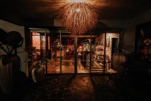 a living room with a glass door and a chandelier at Le Speakeazy in Petite Île +4 photos