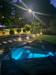 a swimming pool in a yard at night at Port Bobięcino in Bobięcino