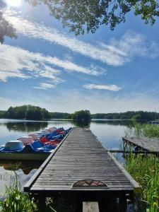 a group of boats parked at a dock on a lake at Port Bobięcino in Bobięcino