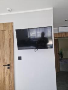 a flat screen tv on top of a white wall at Port Bobięcino in Bobięcino