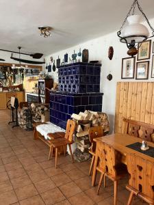 a room with a table and chairs and a fireplace at Zlatá Stezka in Modrava