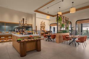 a kitchen with tables and chairs in a room at Four Points by Sheraton Kinshasa in Kinshasa