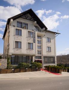 a white building with a black roof at Hotel Paris & SPA in Chişinău