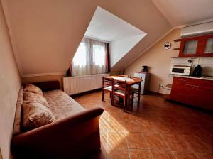 a living room with a couch and a table at Kolbászház Apartman in Gyula