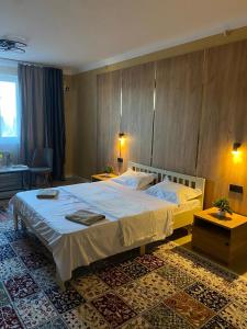a bedroom with a large bed in a room at AIDANA гостиница in Oral
