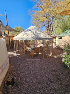 a gazebo with a picnic table in a yard at Loma Sanchez in San Pedro de Atacama