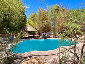 a swimming pool with a gazebo at Loma Sanchez in San Pedro de Atacama