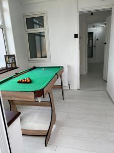 a pool table in the middle of a room at Intimate Hot Tub Pad in Swanscombe