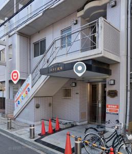 a building with a staircase on the side of it with orange cones at La Pace Awaji in Osaka