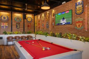 a room with a pool table and a tv at asar Upper House Morjim Beach by Orion Hotels in Morjim