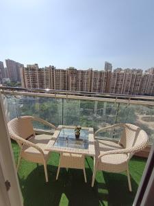 a patio with two chairs and a table on a balcony at Darshana Studios# Couple Friendly in Noida