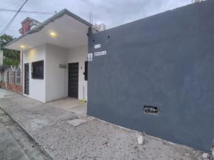 a gray and white building with a door at Casa Camino Real, Habitación 1, Baño privado, Cafetera Escritorio in Ciudad Valles