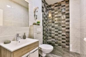a white bathroom with a toilet and a sink at Lux Apartmani Djukic in Bar