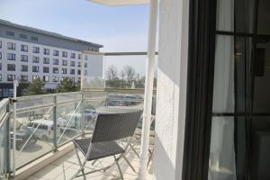 a balcony with two chairs and a view of a parking lot at Haus Titania App 9 inkl WLAN in Grömitz