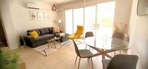 a living room with a glass table and chairs at Nice Groundfloor Apartment - BO202LT in Torre-Pacheco