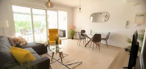 a living room with a couch and a table with chairs at Nice Groundfloor Apartment - BO202LT in Torre-Pacheco +34 photos