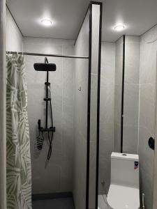 a bathroom with a shower and a toilet in it at AIDANA гостиница in Oral