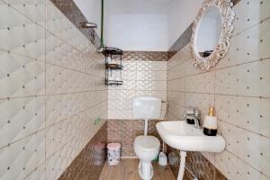 a bathroom with a white toilet and a sink at Bujtina Ethan Perondi - Private Villa Swimming Pool in Kuçovë