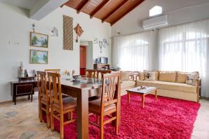 a living room with a table and chairs and a couch at Bujtina Ethan Perondi - Private Villa Swimming Pool in Kuçovë
