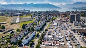 an aerial view of a city with a parking lot at Anstatthotel Cham - self-check-in in Cham
