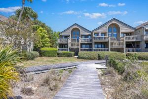 a house on the beach with a boardwalk at 1395 Pelican Watch in Seabrook Island