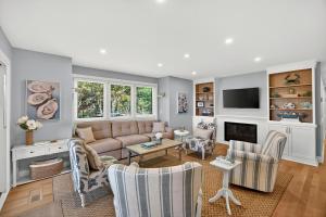 a living room with a couch and a tv at 1395 Pelican Watch in Seabrook Island