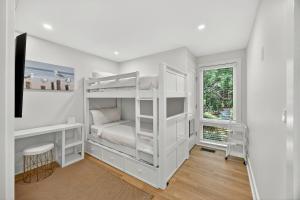 a bedroom with white bunk beds and a window at 1395 Pelican Watch in Seabrook Island +51 photos