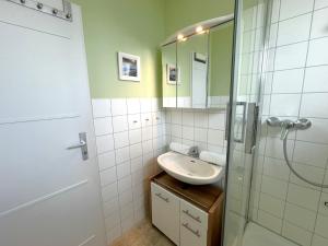 a bathroom with a sink and a shower at Wattenküste in Büsumer Deichhausen +15 photos