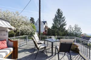 a patio with chairs and a table on a balcony at Fewo-Taunus-Panoramablick in Königstein im Taunus