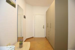 a room with a hallway with a table and a door at Hotel SUNSET GL in Vlorë +17 photos