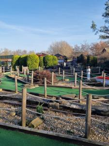 a park with green grass and wooden fences at Haggerston Castle Towerlawn 50 in Cheswick +21 photos