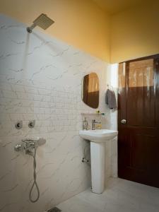a bathroom with a sink and a shower at Grham Hostel & Cafe Kasol, Katagla in Kasol +40 photos