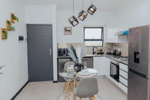 a kitchen with a glass table and a door at Chanty Serenity- workstation, gym, backup power &Pool in Sandton