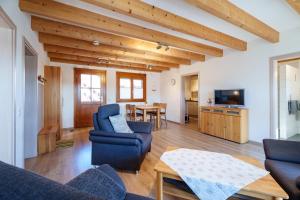 a living room with blue chairs and a table at Dieboldshof in Neuried