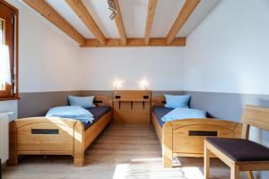 a room with two beds and a table at Dieboldshof in Neuried