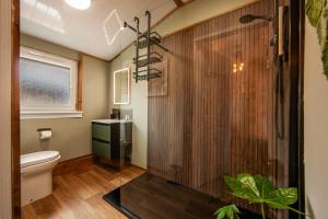 a bathroom with a shower and a toilet at Appin Holiday Homes - Lodges, Shepherds Hut and Train Carriage stays in Appin +266 photos
