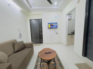 a living room with a couch and a table at B2 601 1BHK Flat by Charter Stays in Hyderabad