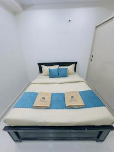 a bed in a room with two certificates on it at B2 601 1BHK Flat by Charter Stays in Hyderabad