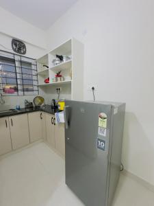 a kitchen with a stainless steel refrigerator in a room at B2 601 1BHK Flat by Charter Stays in Hyderabad