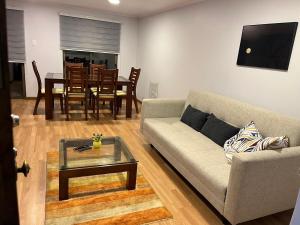 a living room with a couch and a table at Hermosa casa en Talca in Talca