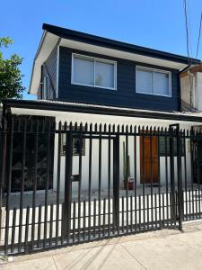 a house with a black fence in front of it at Hermosa casa en Talca in Talca
