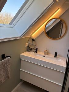 a bathroom with a mirror and a sink at De Strandloper B&B Oostduinkerke in Koksijde +23 photos