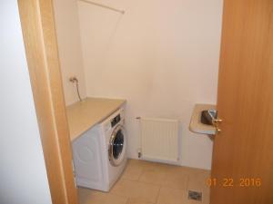 a small bathroom with a washing machine in it at Rez Hlemmur Apartment in Reykjavík