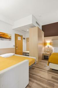 a hotel room with two beds in a room at Hotel Regina in Bolzano +100 photos