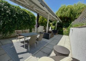 a patio with a table and chairs and an umbrella at Pension Phoenix in Znojmo