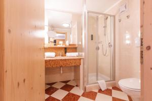 a bathroom with a shower and a sink and a toilet at Ganis Resort in Nova Ponente +57 photos